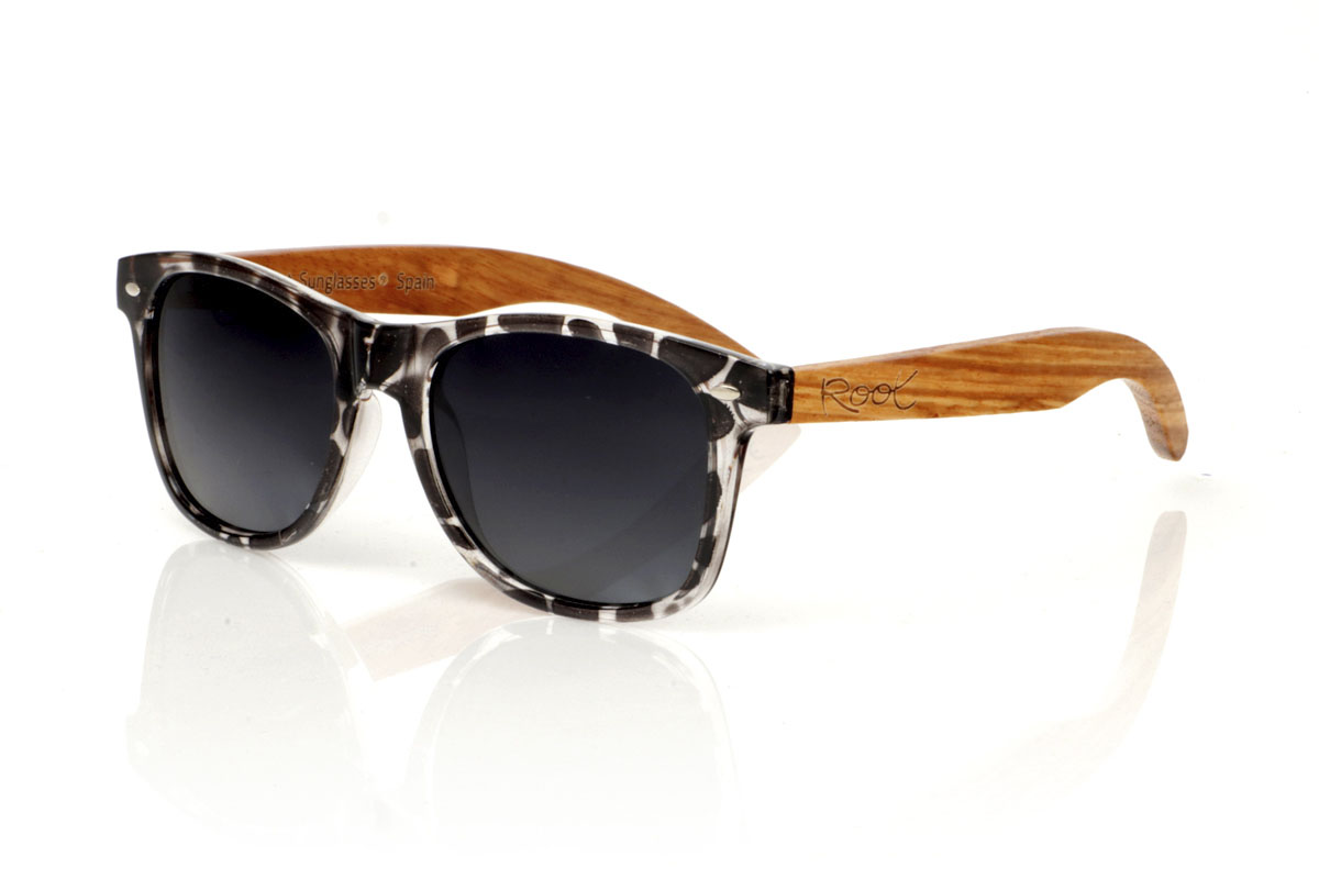 Wood eyewear of Walnut KHUN. KHUN are the new must-have for sunglasses lovers. With its design inspired by the classics, these glasses feature a transparent Tortoiseshell frame in a palette of gray and black with a satin gloss finish, bringing a modern mix to an iconic style. The Walnut temples not only contrast beautifully with the frame, but also add a touch of warmth and naturalness. Perfect for any occasion, the KHUN offers clear vision and protection without compromising style. With measurements of 152x49 and a caliber of 54, they fit perfectly, promising comfort and an impeccable look to those who wear them. for Wholesale & Retail | Root Sunglasses® 